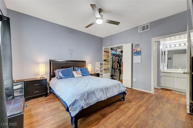 6650 W Warm Springs Rd Unit 1083, Las Vegas, NV 89118 - bedroom featuring light wood-type flooring, a closet, a walk in closet, ceiling fan, and baseboards