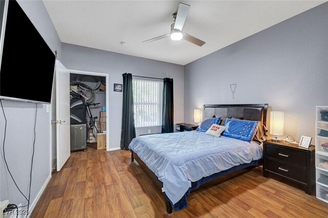 6650 W Warm Springs Rd Unit 1083, Las Vegas, NV 89118 - bedroom with wood finished floors, ceiling fan, baseboards, and a spacious closet