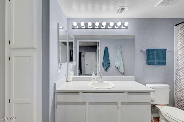 6650 W Warm Springs Rd Unit 1083, Las Vegas, NV 89118 - bathroom with a textured wall, vanity, toilet, a textured ceiling, and a shower with shower curtain
