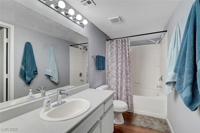 6650 W Warm Springs Rd Unit 1083, Las Vegas, NV 89118 - full bathroom with toilet, vanity, shower / bath combo, wood finished floors, and a textured ceiling