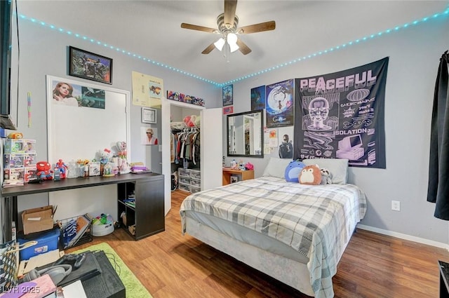 6650 W Warm Springs Rd Unit 1083, Las Vegas, NV 89118 - bedroom with wood finished floors, a spacious closet, baseboards, and a closet