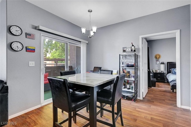 6650 W Warm Springs Rd Unit 1083, Las Vegas, NV 89118 - dining area with light wood finished floors, a chandelier, and baseboards