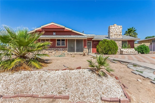 812 Pyramid Dr, Las Vegas, NV 89107 - view of front of house featuring stone siding and a chimney
