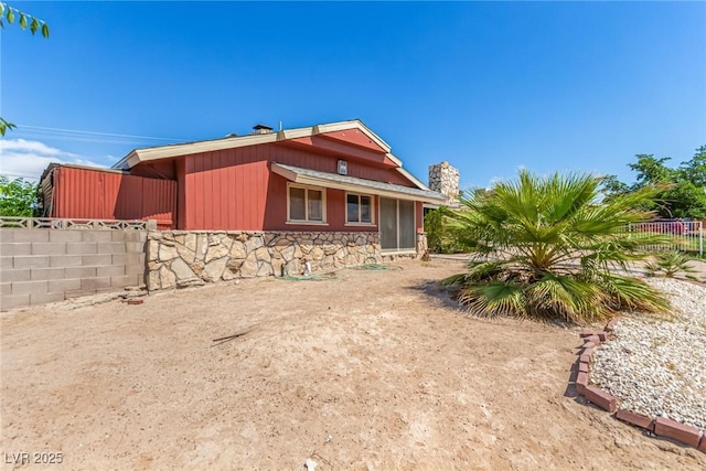 812 Pyramid Dr, Las Vegas, NV 89107 - view of side of property with stone siding and a chimney