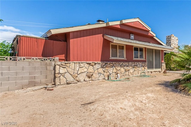 812 Pyramid Dr, Las Vegas, NV 89107 - view of property exterior with stone siding and a chimney