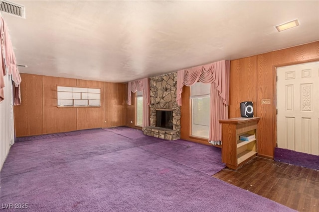 812 Pyramid Dr, Las Vegas, NV 89107 - unfurnished living room featuring a stone fireplace and wooden walls
