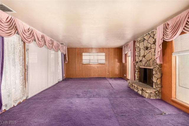 812 Pyramid Dr, Las Vegas, NV 89107 - unfurnished living room with carpet flooring, a fireplace, and wood walls