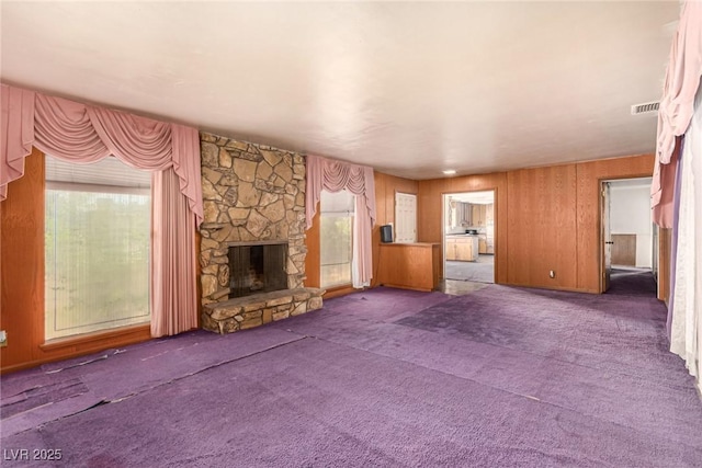 812 Pyramid Dr, Las Vegas, NV 89107 - unfurnished living room with plenty of natural light, carpet, and a stone fireplace
