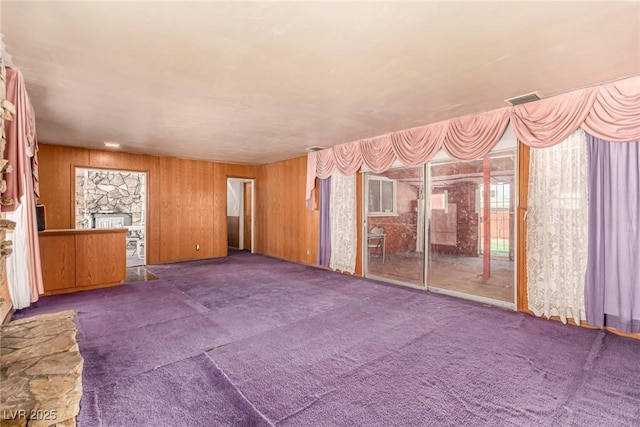 812 Pyramid Dr, Las Vegas, NV 89107 - unfurnished living room with carpet floors and wooden walls