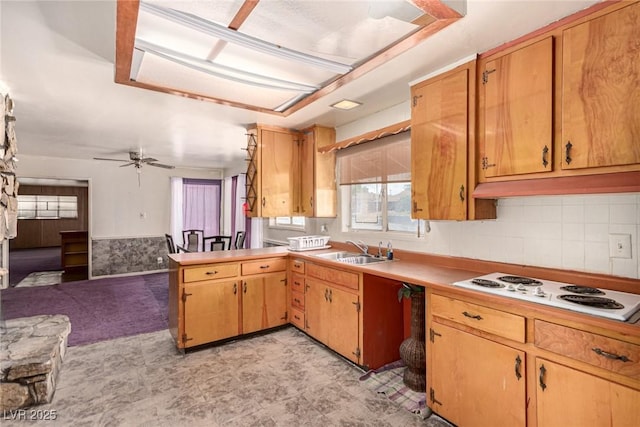 812 Pyramid Dr, Las Vegas, NV 89107 - kitchen featuring a sink, white electric cooktop, ceiling fan, light flooring, and a peninsula