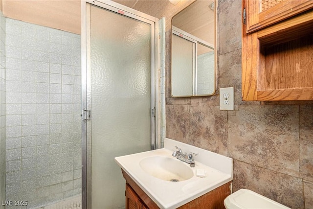 812 Pyramid Dr, Las Vegas, NV 89107 - bathroom featuring a shower stall, vanity, toilet, and tile walls
