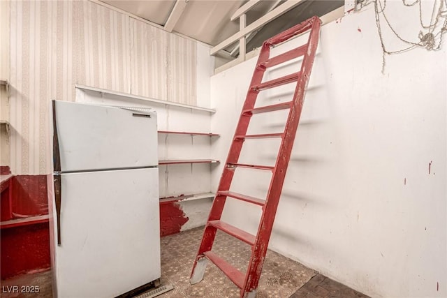 812 Pyramid Dr, Las Vegas, NV 89107 - unfinished below grade area with freestanding refrigerator, tile patterned floors, and wallpapered walls
