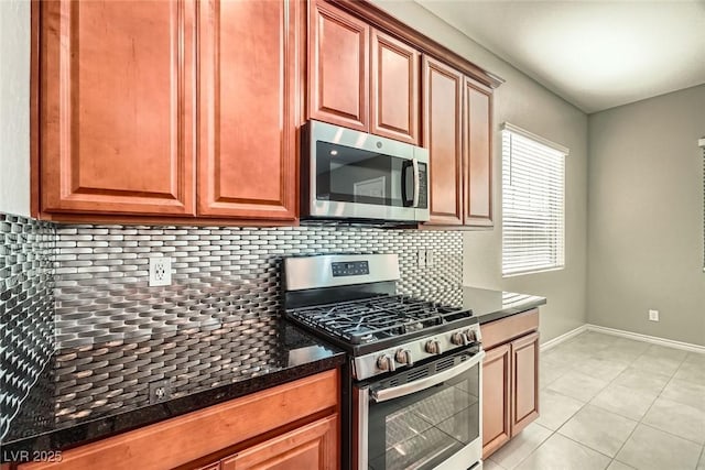 208 Coltrane Canyon Ave, Henderson, NV 89011 - kitchen featuring appliances with stainless steel finishes, decorative backsplash, baseboards, and light tile patterned floors