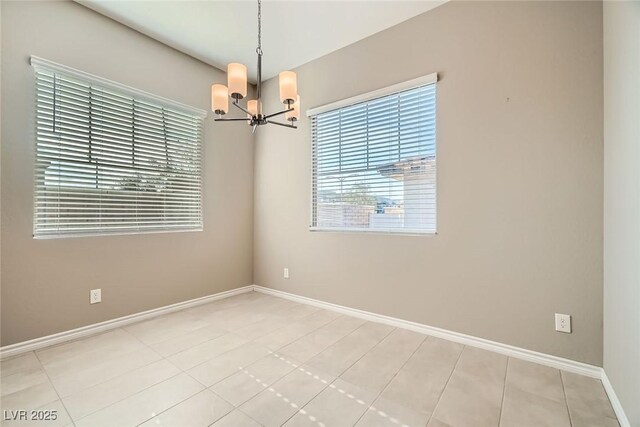 208 Coltrane Canyon Ave, Henderson, NV 89011 - empty room with a chandelier, baseboards, and light tile patterned floors