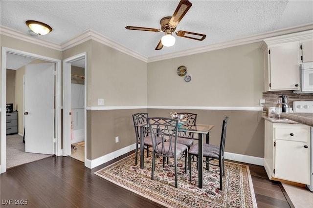3150 Soft Breezes Dr Unit 1040, Las Vegas, NV 89128 - dining space featuring ceiling fan, a textured ceiling, dark wood-style flooring, crown molding, and baseboards