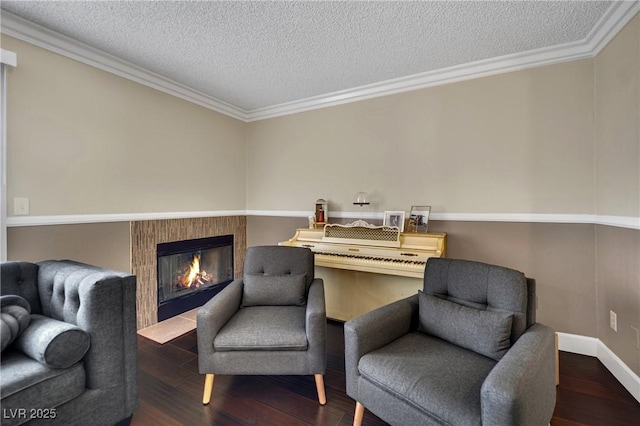3150 Soft Breezes Dr Unit 1040, Las Vegas, NV 89128 - living area with crown molding, wood finished floors, a textured ceiling, a glass covered fireplace, and baseboards
