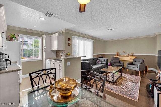 3150 Soft Breezes Dr Unit 1040, Las Vegas, NV 89128 - living room with a textured ceiling, crown molding, light wood-style floors, and baseboards