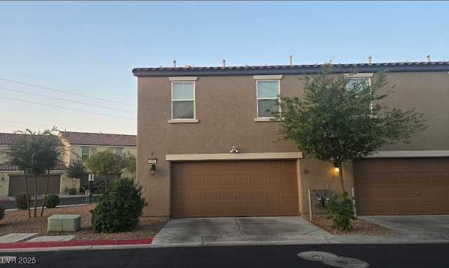 5209 Silica Chalk Ave, Las Vegas, NV 89115 - view of front of property with stucco siding, driveway, a garage, and a tile roof