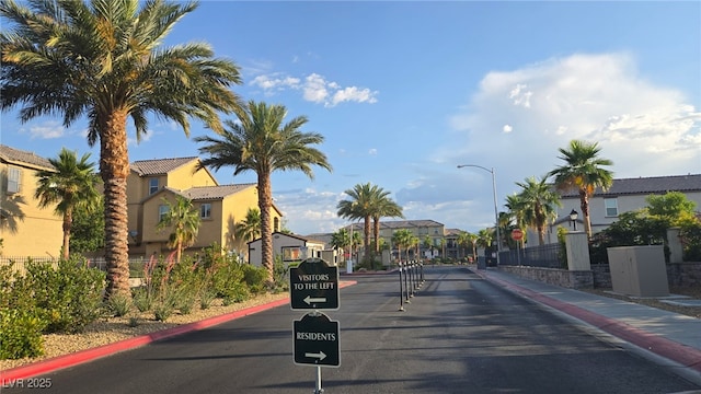5209 Silica Chalk Ave, Las Vegas, NV 89115 - view of asphalt street with a residential view, curbs, traffic signs, street lights, and sidewalks