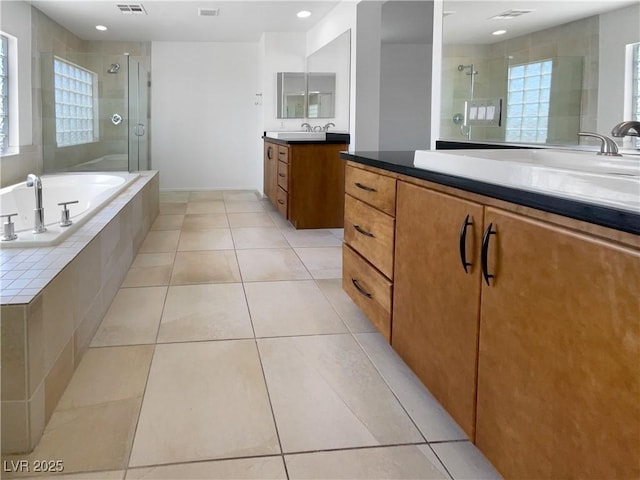 9384 Hosner St, Las Vegas, NV 89178 - bathroom with a shower stall, two vanities, healthy amount of natural light, a garden tub, and recessed lighting