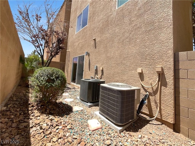 9384 Hosner St, Las Vegas, NV 89178 - view of side of property with cooling unit and stucco siding