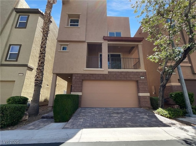 9384 Hosner St, Las Vegas, NV 89178 - view of front of property featuring an attached garage, stucco siding, driveway, and stone siding