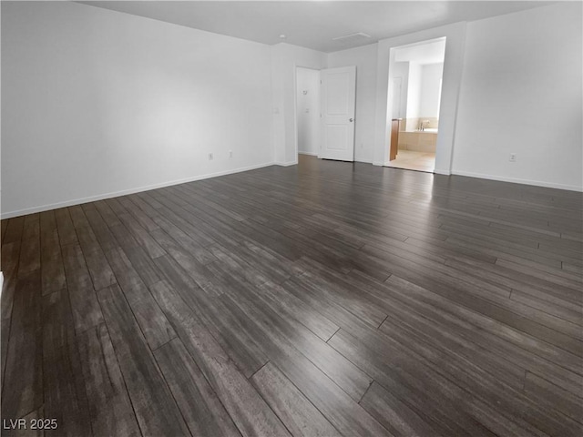 9384 Hosner St, Las Vegas, NV 89178 - spare room featuring dark wood-style flooring and baseboards