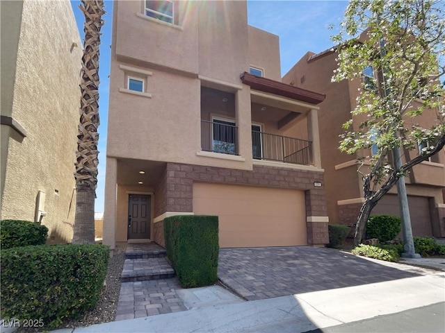 9384 Hosner St, Las Vegas, NV 89178 - view of front of house featuring a garage, stucco siding, driveway, and stone siding