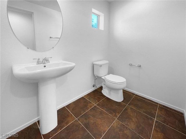 9384 Hosner St, Las Vegas, NV 89178 - bathroom featuring toilet, baseboards, and a sink
