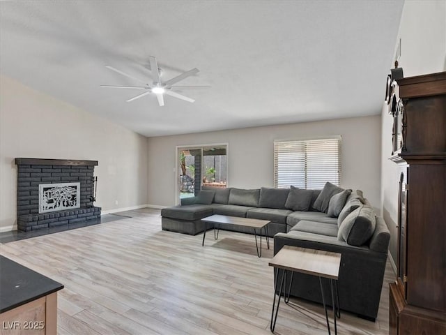 6436 Vinecrest Ave, Las Vegas, NV 89108 - living room featuring lofted ceiling, a ceiling fan, light wood-style flooring, and a brick fireplace