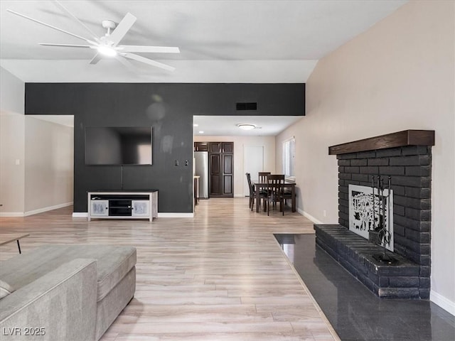 6436 Vinecrest Ave, Las Vegas, NV 89108 - living room with a brick fireplace, light wood-style floors, and ceiling fan