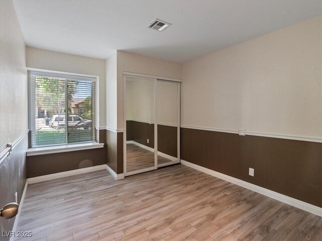 6436 Vinecrest Ave, Las Vegas, NV 89108 - unfurnished bedroom with wood finished floors and a closet