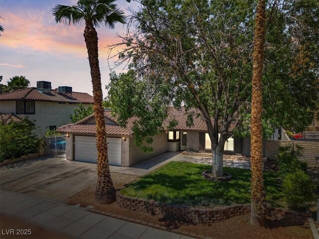6436 Vinecrest Ave, Las Vegas, NV 89108 - view of front facade with driveway, stucco siding, a garage, and a tile roof