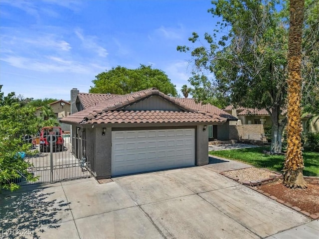6436 Vinecrest Ave, Las Vegas, NV 89108 - mediterranean / spanish house featuring a tile roof, stucco siding, concrete driveway, and a gate