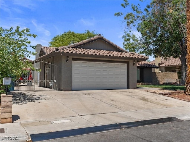 6436 Vinecrest Ave, Las Vegas, NV 89108 - view of front of house featuring a tile roof, stucco siding, and concrete driveway