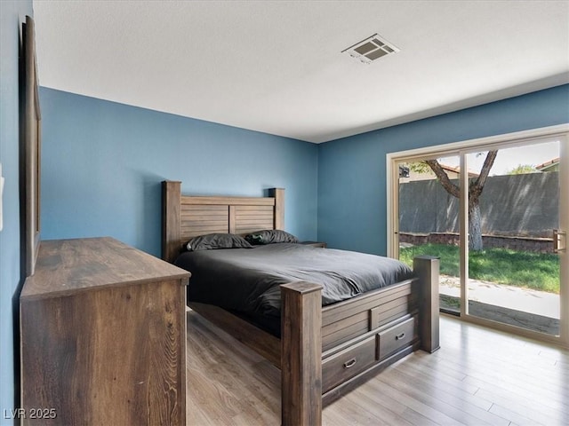 6436 Vinecrest Ave, Las Vegas, NV 89108 - bedroom with access to exterior and wood finished floors