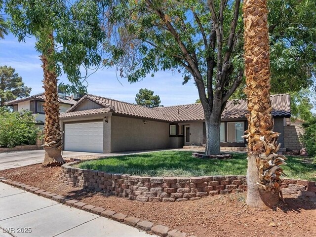 6436 Vinecrest Ave, Las Vegas, NV 89108 - ranch-style house with a tiled roof, stucco siding, a garage, concrete driveway, and a front lawn