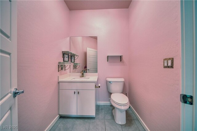 5091 E Beacon Ridge Dr, Pahrump, NV 89061 - half bath with vanity, toilet, tile patterned floors, and baseboards