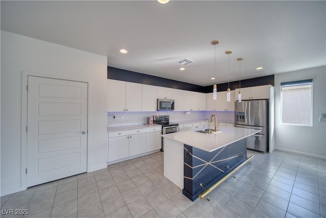 5091 E Beacon Ridge Dr, Pahrump, NV 89061 - kitchen with appliances with stainless steel finishes, a sink, decorative backsplash, white cabinetry, and light countertops
