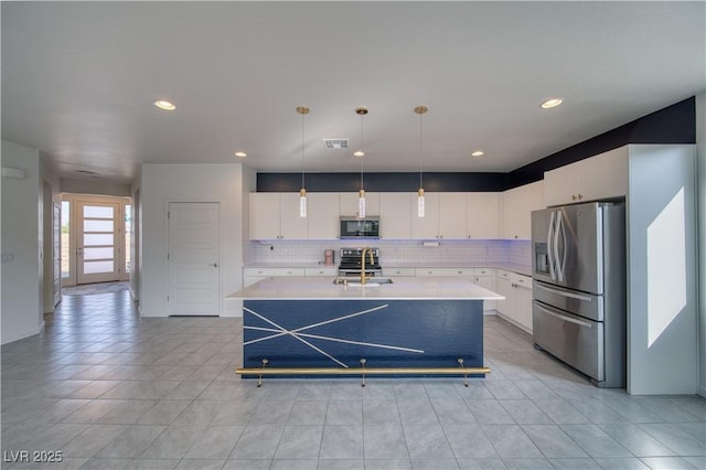 5091 E Beacon Ridge Dr, Pahrump, NV 89061 - kitchen with appliances with stainless steel finishes, light countertops, backsplash, and recessed lighting