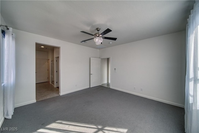 5091 E Beacon Ridge Dr, Pahrump, NV 89061 - unfurnished bedroom with dark colored carpet, baseboards, and a ceiling fan