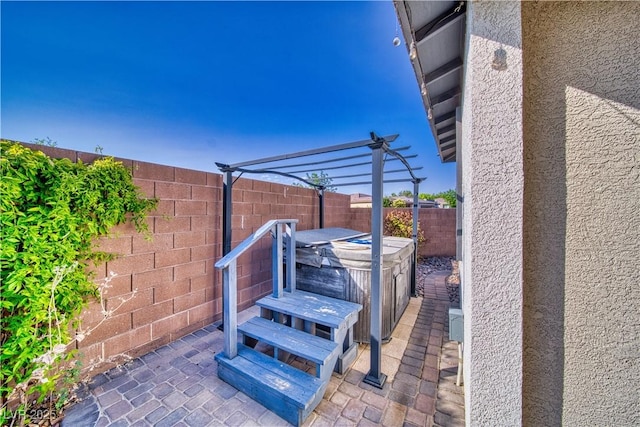 5091 E Beacon Ridge Dr, Pahrump, NV 89061 - fenced backyard featuring a hot tub, a patio area, and a pergola