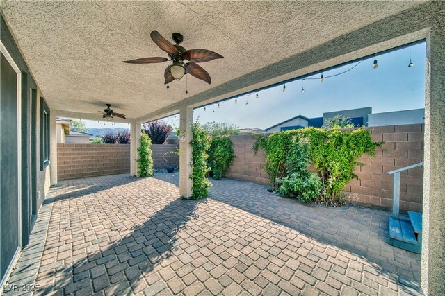 5091 E Beacon Ridge Dr, Pahrump, NV 89061 - fenced backyard with a ceiling fan and a patio