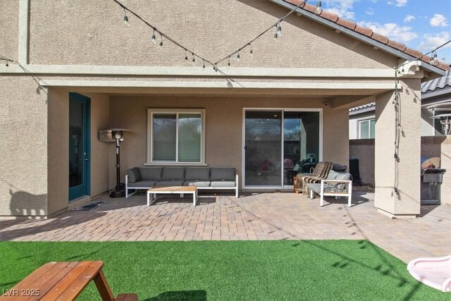 7616 Quail Dust St, North Las Vegas, NV 89084 - back of property with a patio area, outdoor lounge area, and stucco siding