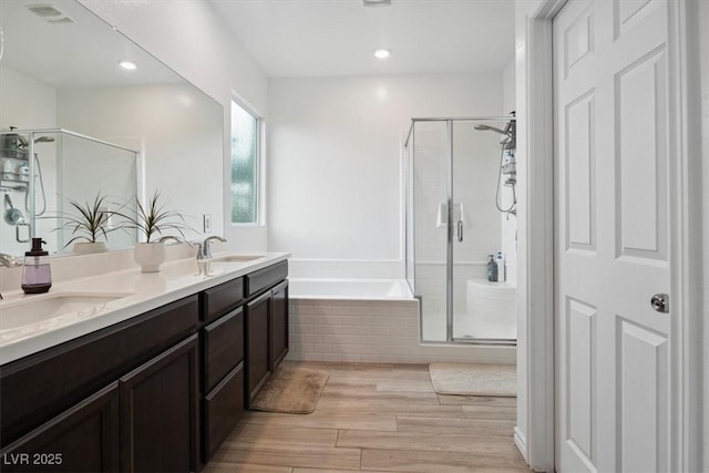 7616 Quail Dust St, North Las Vegas, NV 89084 - full bath with a shower stall, a garden tub, wood finished floors, double vanity, and recessed lighting
