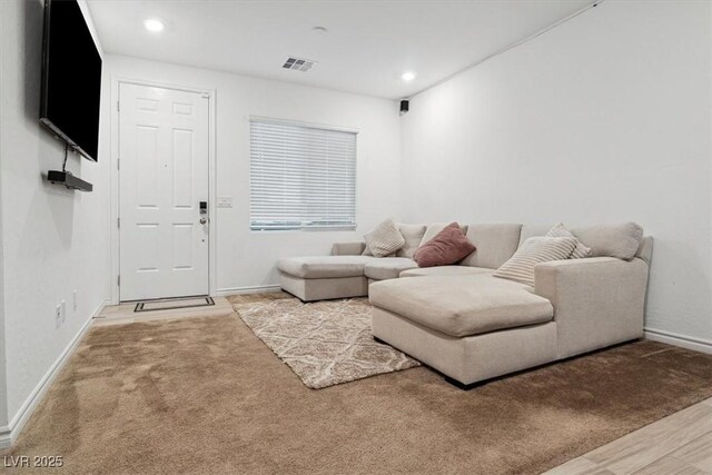 7616 Quail Dust St, North Las Vegas, NV 89084 - living room with baseboards, recessed lighting, and light carpet