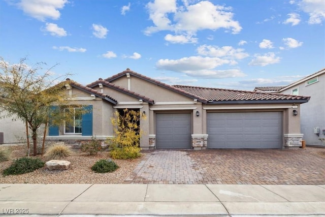 7616 Quail Dust St, North Las Vegas, NV 89084 - view of front facade with stone siding, stucco siding, decorative driveway, and a garage