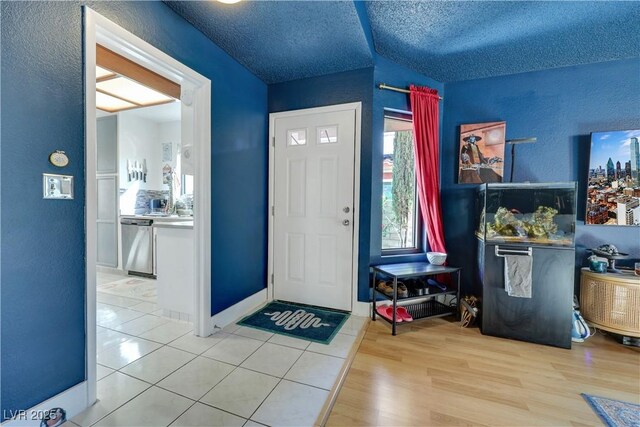 4629 Denwood Dr, Las Vegas, NV 89147 - entryway with a textured wall, a textured ceiling, and light wood-type flooring