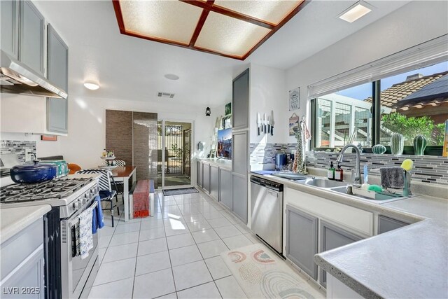 4629 Denwood Dr, Las Vegas, NV 89147 - kitchen featuring stainless steel appliances, decorative backsplash, and healthy amount of natural light