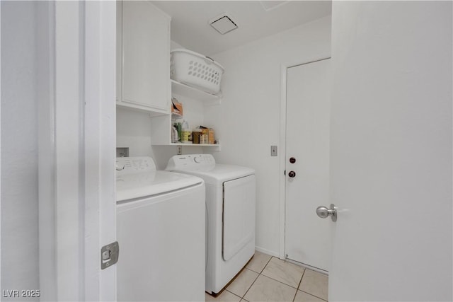4629 Denwood Dr, Las Vegas, NV 89147 - washroom with washer and dryer, light tile patterned floors, and cabinet space